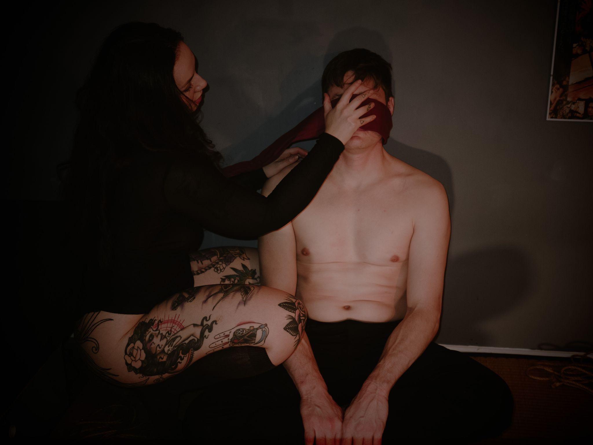 A red rope harness tied across the torso